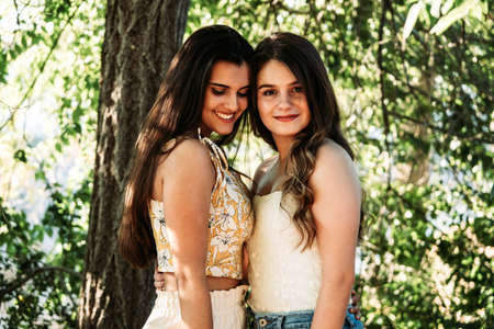two young women friends in the forest with trees in the backgroundの写真素材