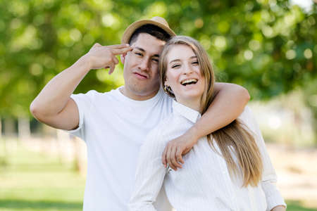 Young couple posing and watching camera. Latin man and Caucasian woman looking at camera happy and smilingの写真素材