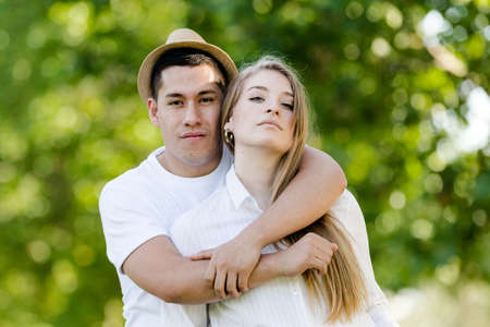 Young couple posing and watching camera. Latin man and Caucasian woman looking at camera happy and smilingの写真素材