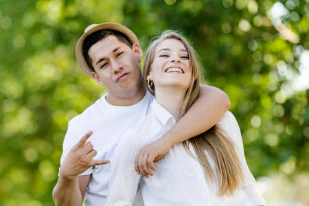 Young couple posing and watching camera. Latin man and Caucasian woman looking at camera happy and smilingの写真素材