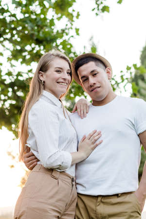 Young couple posing and watching camera. Latin man and Caucasian woman looking at camera happy and smilingの写真素材