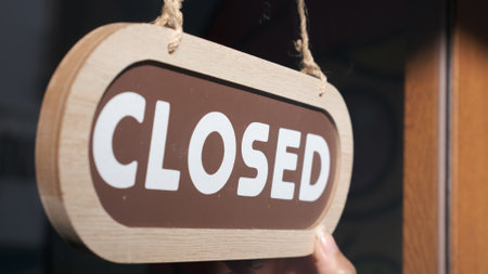 Small business close. Turning the sign to closedの写真素材