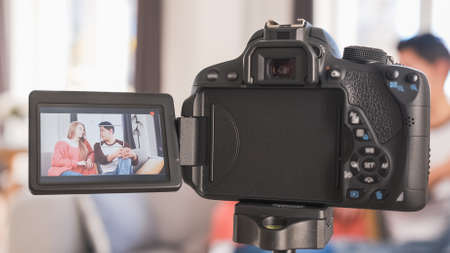 Young couple talking to camera on screen. Woman and man recording a video blogの写真素材