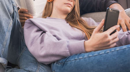 Close up of a couple relaxing and spending time together on the couch while staying at homeの写真素材