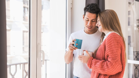 Portrait of young couple relaxing and enjoying time together while having coffeeの写真素材
