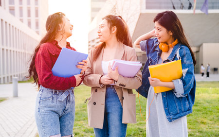 Asian college students having good time together after class at the university campus. Education concept.の写真素材