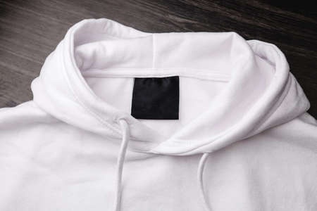 Empty black label on white sweatshirt for logo, size and info.の写真素材