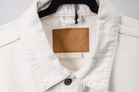 Blank clothing label on denim jacket texture. Label with empty space for text.の写真素材