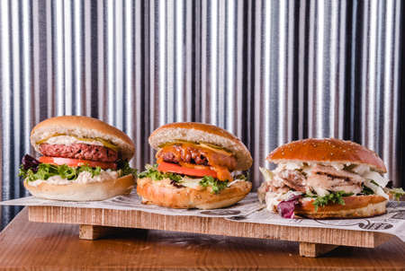 Delicious loaded vegan, veggie and chicken burgers. Food and healthy eating concept.の写真素材