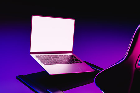 Mock up of laptop next to a gamers chair, 3d renderの写真素材