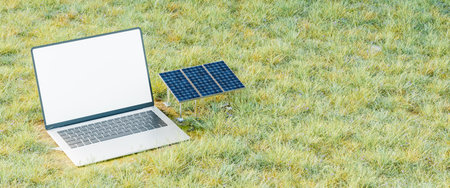 Laptop next to solar panels figures in the groundの写真素材