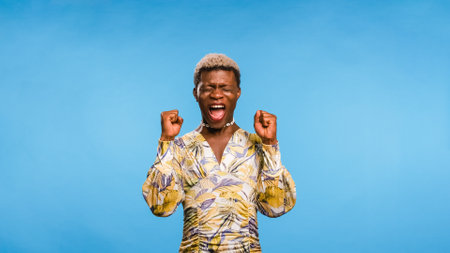 Black African model winner screaming on blueの写真素材