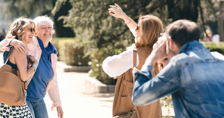 Man shooting mature women dancing in parkの写真素材