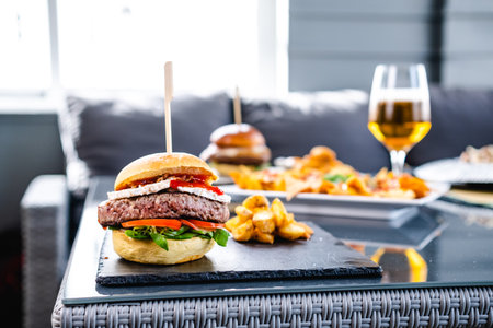 Delicious burger with potatoes and beerの写真素材