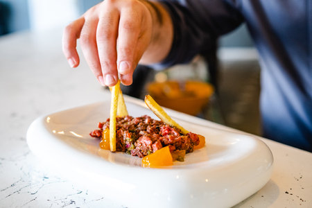 Crop person serving steak tartareの写真素材