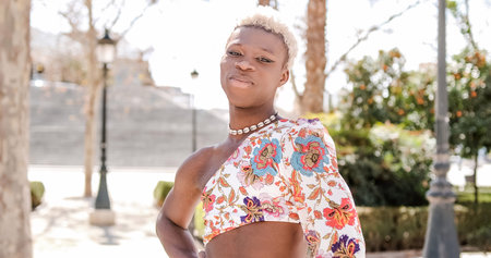 Transgender person looking at the camera and smiling while posing outdoors.の写真素材