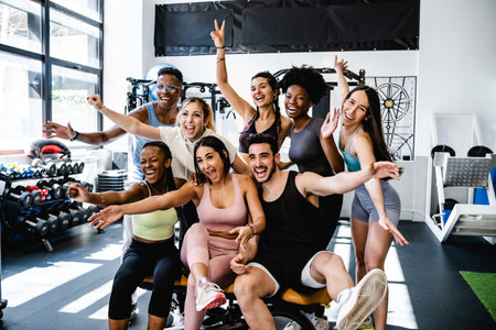 Happy diverse sportspeople having fun in fitness club togetherの写真素材