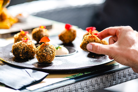 Crop person eating delicious appetizerの写真素材