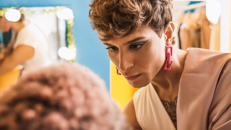 Beauty transgender man making up a colleague in a dressing room