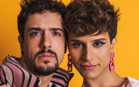 Man and trans woman in makeup looking at the cameraの写真素材