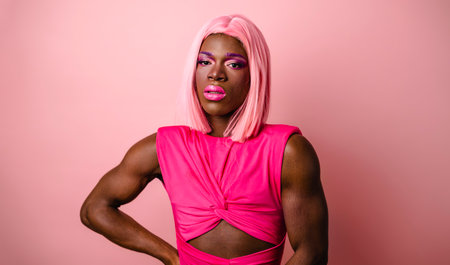 Muscular black transgender model wearing pink dressの写真素材