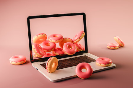 3d rendering of laptop with donuts placed on pink surfaceの写真素材