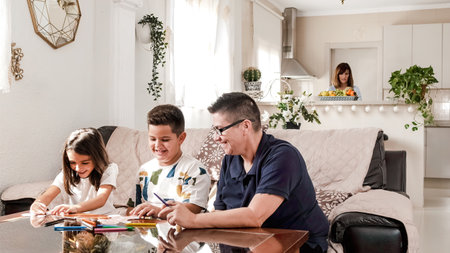 Family doing crafts and painting at homeの写真素材