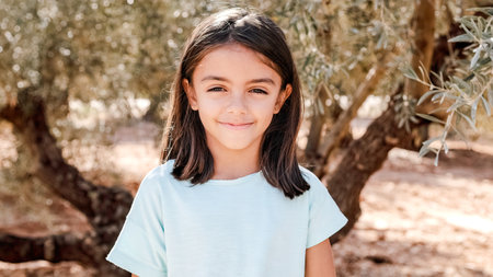 Girl smiling at camera outdoorsの写真素材