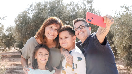 Family taking selfie during an excursion on a rural areaの写真素材