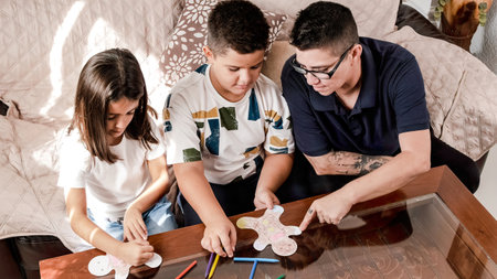 High angle view of a family doing crafts and painting at homeの写真素材