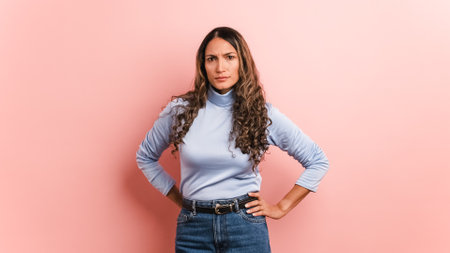 Serious hispanic woman looking at the camera with angry expressionの写真素材