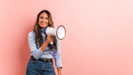 Colombian woman using a loudspeaker and yelling positiveの写真素材