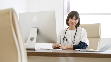 Portrait of smiling young female doctor in modern clinicの写真素材