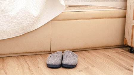 Slippers out of bed in floorの写真素材