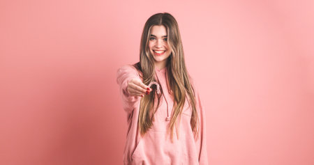 Smiling woman showing an invisible silicone aligner for dental correctionの写真素材