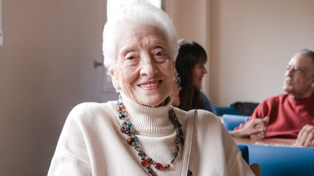 Portrait of smiling senior woman sitting in nursing homeの写真素材