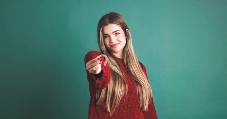 Smiling woman showing an invisible silicone aligner for dental correctionの写真素材