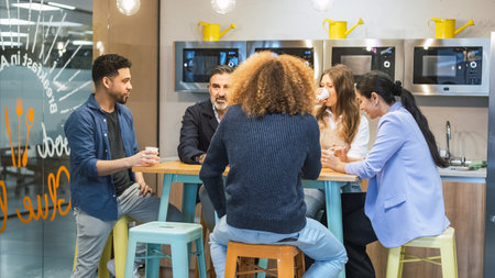 Businesspeople enjoying coffee break in canteen at officeの写真素材