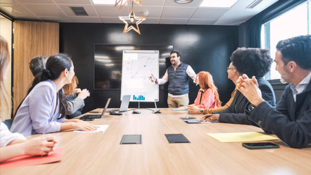 Businessman explaining line graph on whiteboard to diverse colleagues in office