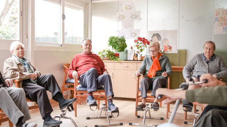 Elderly people doing pedal exercises at rehabilitation center