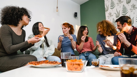 Cheerful friends enjoying delicious pizza slices in living room during party at home