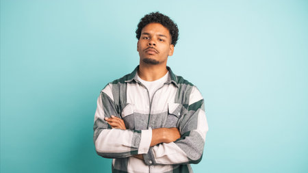 Disagreeing young man shaking head in blue studioの写真素材