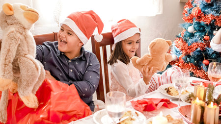 Happy family exchanging christmas presents at homeの写真素材