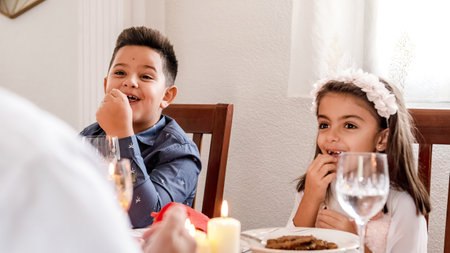 Happy kids during Christmas lunchの写真素材