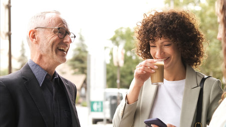 Cheerful business people enjoying coffee break outdoorsの写真素材