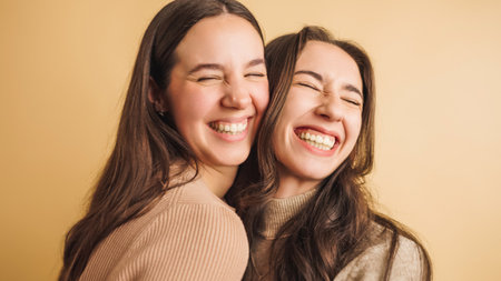 Two friends sharing a joyful moment togetherの写真素材