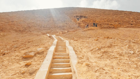 Tourists climbing the bent pyramid of sneferu in dahshur, egyptの写真素材