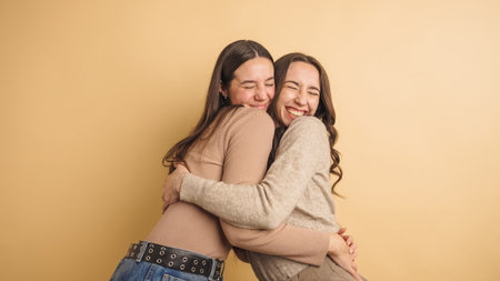 Joyful friends embracing in warm harmonyの写真素材