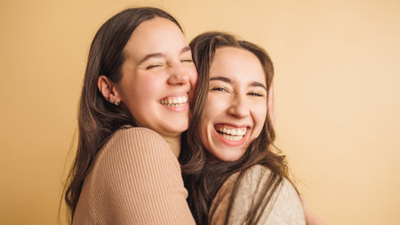 Two women embracing with joyful smilesの写真素材