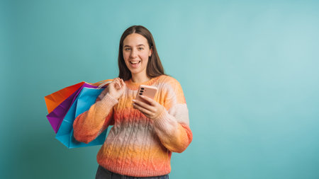 Young woman enjoying shopping with colorful bagsの写真素材